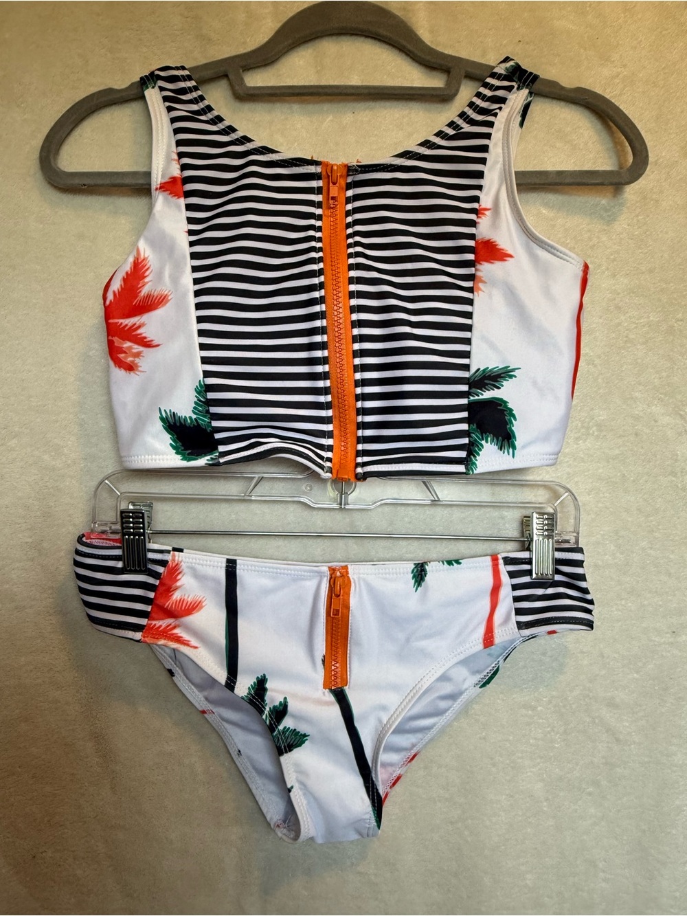 Woman’s Two-Piece Palm Stripe Swim Set with Orange Zipper